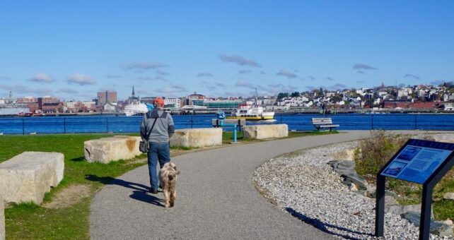 The park at the Bug Light lighthouse is a popular spot for runners, bicyclists and dog walkers. South Portlander Mark MacIsaac, shown here with his dog Phoebe, is among the locals who use the park on a regular basis. Photo by Cindy Barks.