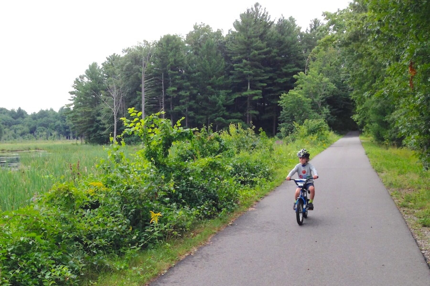 Child riding bicycle on New Hampshire's Derry Rail Trail | Photo by Ben Carter