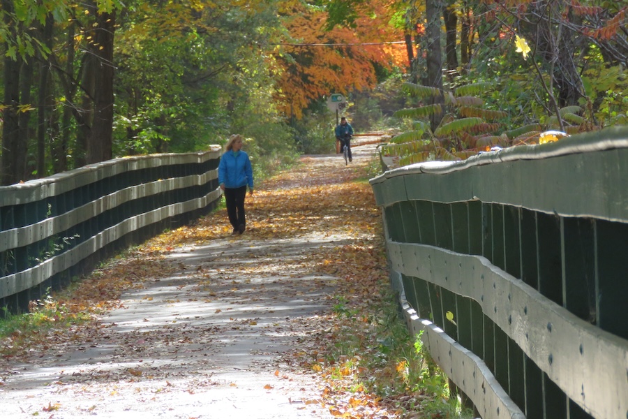 Walker and bicyclist on New Hampshire's Derry Rail Trail | Photo Courtesy Derry Rail Trail Alliance