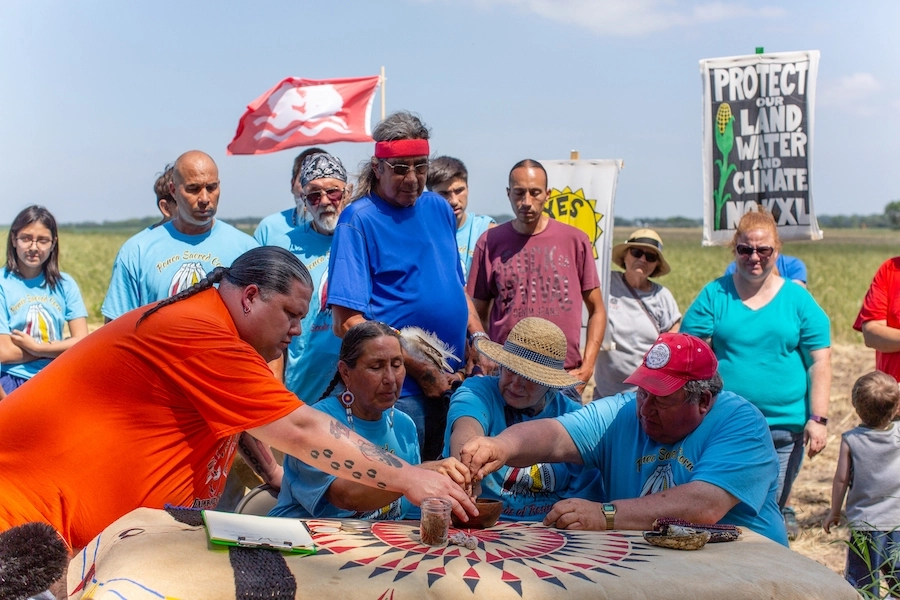 On June 10, 2018, Art and Helen Tanderup deeded a portion of their farm to the Ponca Nation in a public ceremony. Front, left to right are: Ponca Tribe of Nebraska Chairman Larry Wright, Jr., Ponca Nation of Oklahoma Councilwoman Casey Camp-Horinek, Helen and Art Tanderup. | Photo by Alex Matzke, courtesy Bold Nebraska