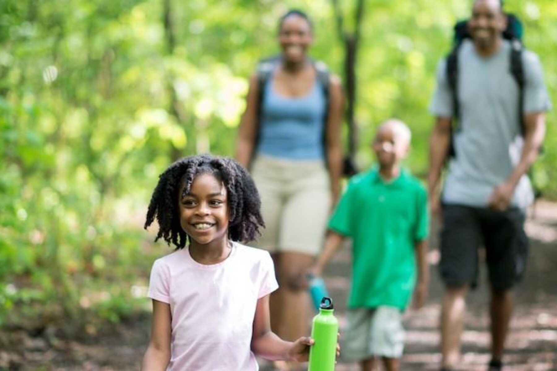 Black family walking in woods - Photo courtesy iStock by Getty Images