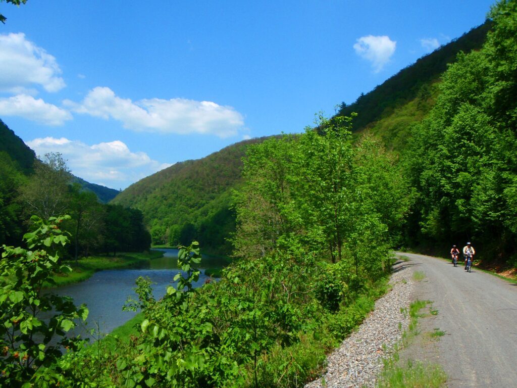 The rail-trail is nestled within forested canyon walls alongside beautiful Pine Creek | Photo courtesy Pine Creek Outfitters, Inc.