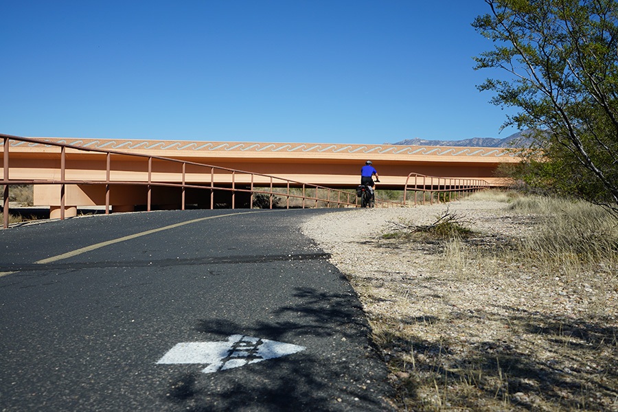 Painted arrows mark the locations of artwork along the trail system, including this one on the Cañada del Oro River Park Trail alerting trail users to a work of rock art. | Photo by Cindy Barks