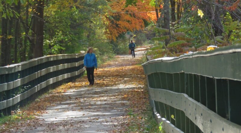 Walker and bicyclist on New Hampshire's Derry Rail Trail | Photo Courtesy Derry Rail Trail Alliance