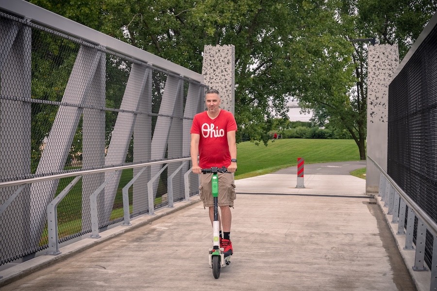 E-scooter user on Ohio's Cleveland Foundation Centennial Lake Link Trail | Photo by Renee Rosensteel