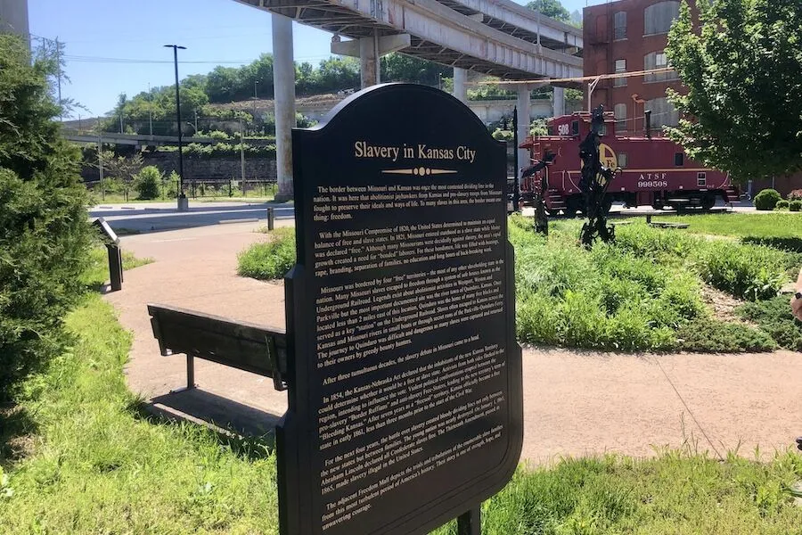 A commemorative sign at the Freedom Mall in Kansas City along the riverfront trail explains the role that the Missouri/Kansas border played in the fight to abolish slavery. &ldquo;The border between Missouri and Kansas was once the most contested dividing line in the nation,&rdquo; it says, adding that &ldquo;[t]o many slaves in this area, the border meant one thing: freedom.&rdquo; | Photo by Cindy Barks