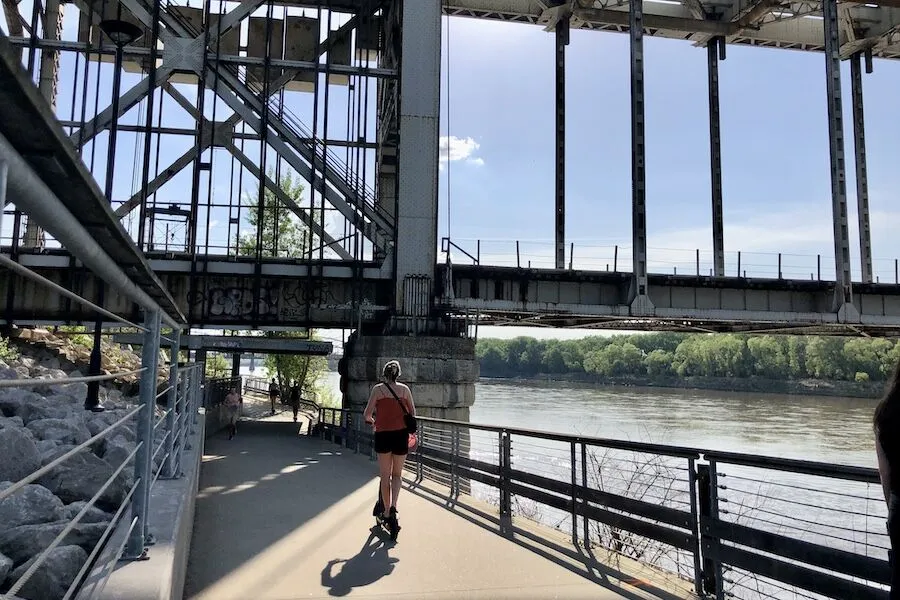 The Riverfront Heritage Trail passes under the ASB (Armour-Swift-Burlington Bridge), a stretch along the Missouri River that is popular with scooter riders and cyclists. | Photo by Cindy Barks The Riverfront Heritage Trail passes under the ASB (Armour-Swift-Burlington Bridge), a stretch along the Missouri River that is popular with scooter riders and cyclists. | Photo by Cindy Barks