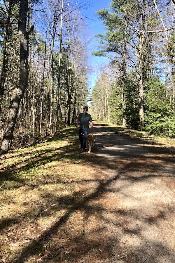Arundel resident Greg Raine walks his son’s dog Zoey along a wooded section of the Eastern Trail in the Kennebunk area. From Kennebunk, the trail continues south toward Kittery. Photo by Cindy Barks. Arundel resident Greg Raine walks his son’s dog Zoey along a wooded section of the Eastern Trail in the Kennebunk area. From Kennebunk, the trail continues south toward Kittery. Photo by Cindy Barks.