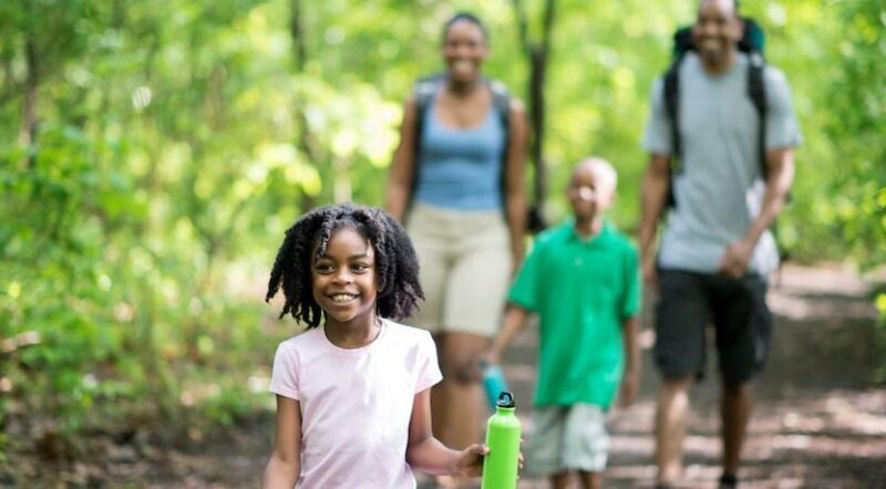 Black family walking in woods - Photo courtesy iStock by Getty Images