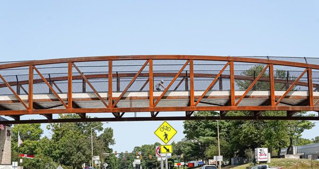 Opened in the summer of 2024, this 147-foot-long pedestrian bridge on the W&OD Trail provides safe crossings for people over busy Wiehle Avenue in Reston, Virginia. | Photo by Albert Ting