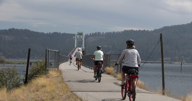 Bicyclists approaching the Chatcolet Bridge on Idaho's Trail of the Coeur d'Alenes | Photo by Glenn Zinkus