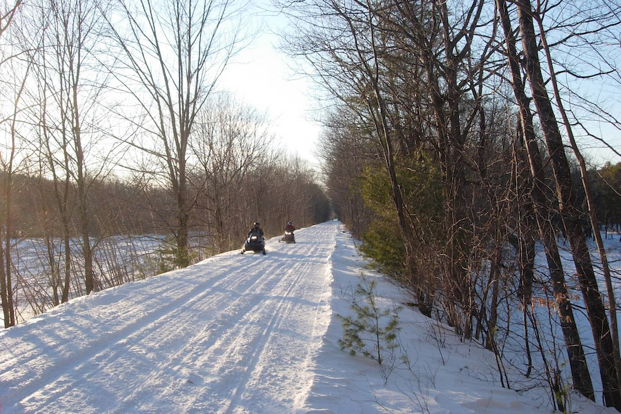 snowmobilers in winter on New Hampshire's Northern Rail Trail | Photo courtesy Friends of the Northern Rail Trail