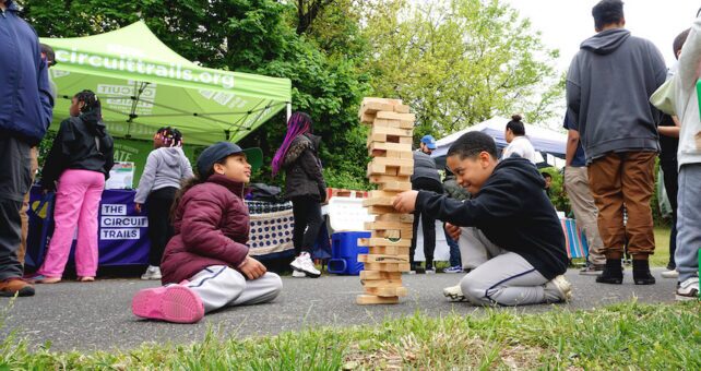 Children enjoying a game of Jenga in New Jersey's Stockton Station Park | Photo by Frank Santos