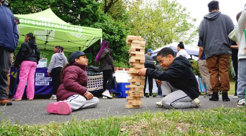 Children enjoying a game of Jenga in New Jersey's Stockton Station Park | Photo by Frank Santos
