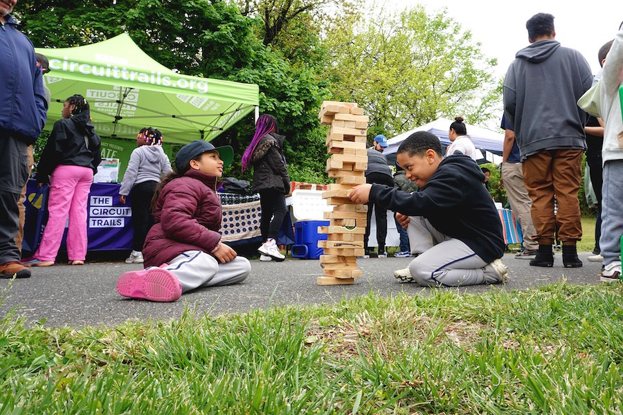 Children enjoying a game of Jenga in New Jersey's Stockton Station Park | Photo by Frank Santos