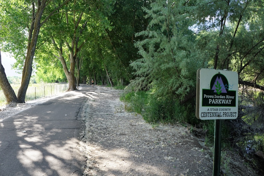Trees and thick foliage border the Provo River Parkway in Provo, Utah. The 15.2-mile trail connects with several other rail-trails in the area. | Photo by Cindy Barks