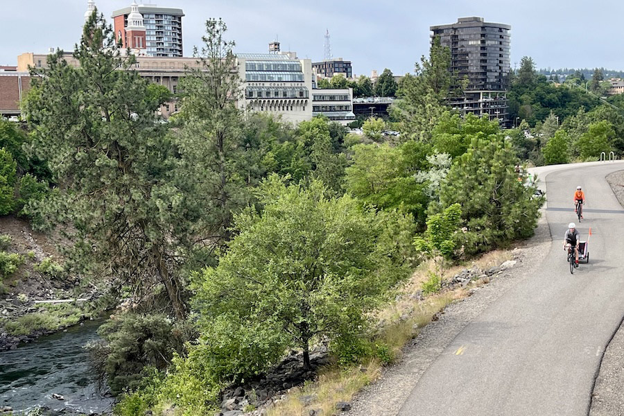 The Spokane River trail passes under the historical Monroe Bridge and heads toward Spokane’s Kendall Yards business area. Photo by Cindy Barks