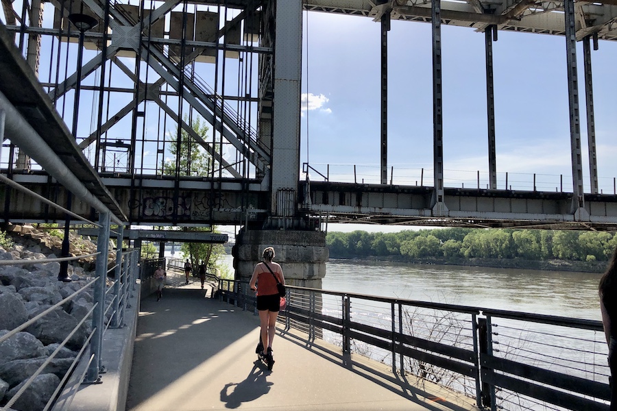 The Riverfront Heritage Trail passes under the ASB (Armour-Swift-Burlington Bridge), a stretch along the Missouri River that is popular with scooter riders and cyclists. | Photo by Cindy Barks