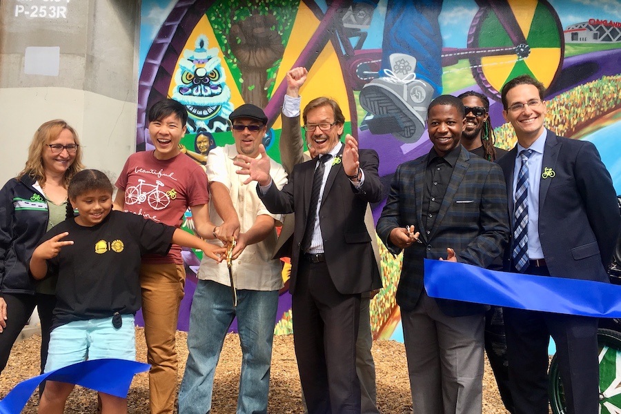 RTC and local partners in California celebrate the launch of two new trail murals in Oakland in 2018, to help promote the developing East Bay Greenway. | Photo courtesy Bike East Bay