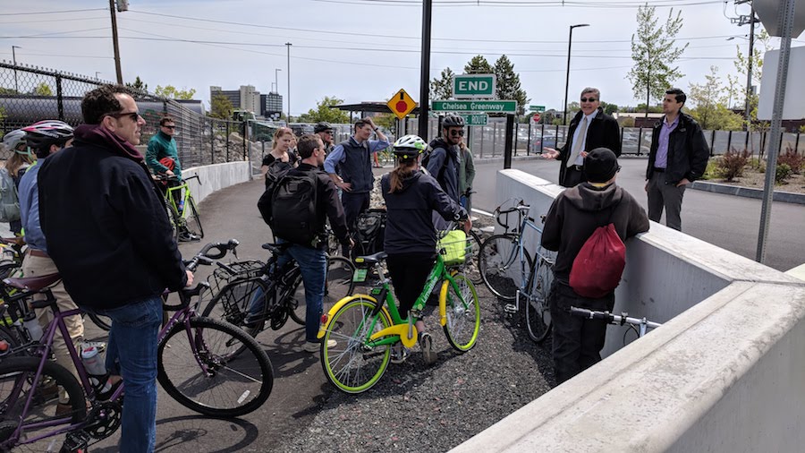 At a bike ride following the rollout of the LandLine Vision Plan in Malden, Massachusetts, riders stop to hear a talk by the Everett City Manager about the newly opened Chelsea Greenway and adjacent Bus Rapid Transit corridor. | Photo by David Loutzenheiser
