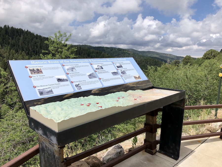 A display at the Cloud-Climbing Railroad Vista Overlook illustrates the steep terrain that the Alamogordo & Sacramento Mountain Railroad followed on its route from Cloudcroft to Alamogordo. At 8,650-feet in elevation, Cloudcroft is among the high-elevation communities of the United States | Photo by Cindy Barks