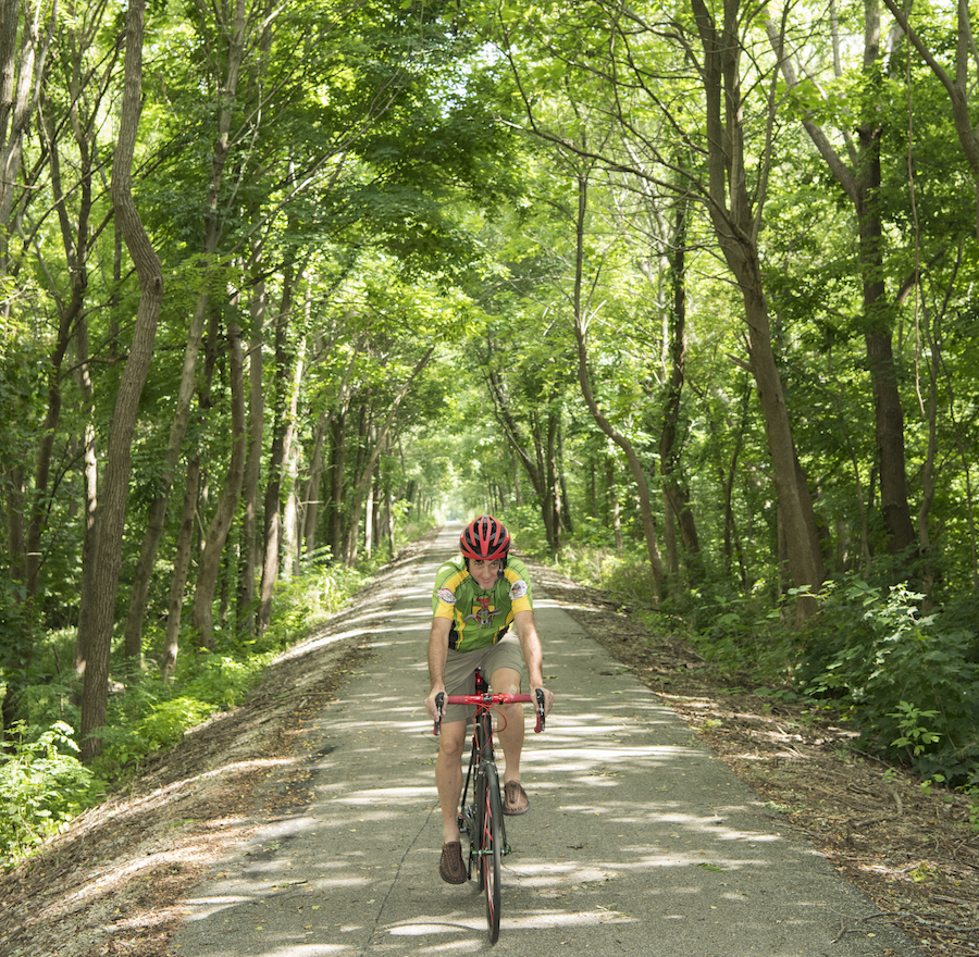 A trail user enjoys a peaceful ride along the Cardinal Greenway near the Medford Trailhead. | Photo by Tony Valainis