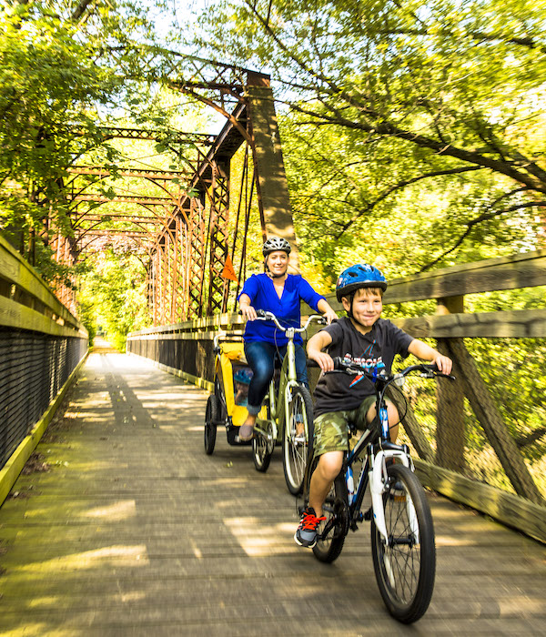 Adria Hamel with son Jacob and daughter Hailey enjoy a bike ride over the Sangamon River Trail bridge, which runs along the Heartland Pathways. | Photo by Chris Bucher