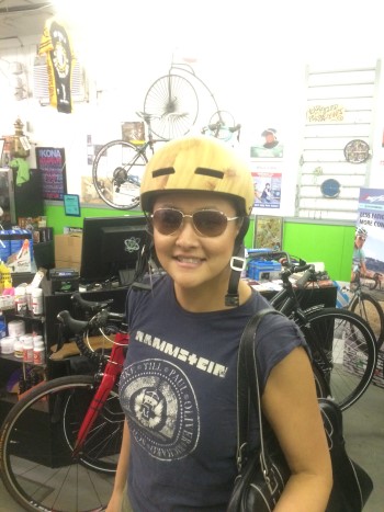 Amy Kapp trying on helmets, June 2015 | Photo by Elissa Southward