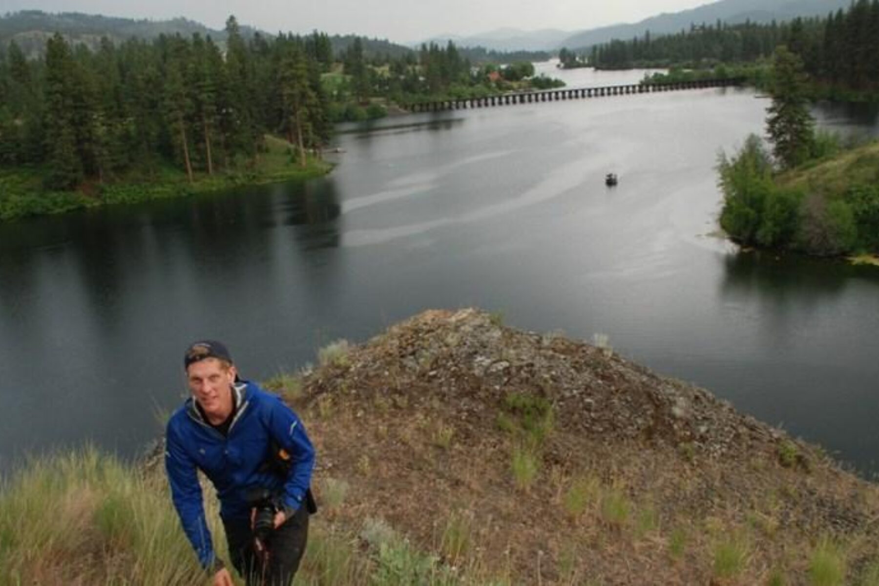 Bobby Whittaker, president of Ferry County Rail Trail Partners, with 770-foot trestle over Curlew Lake in background | Photo by Rich Landers