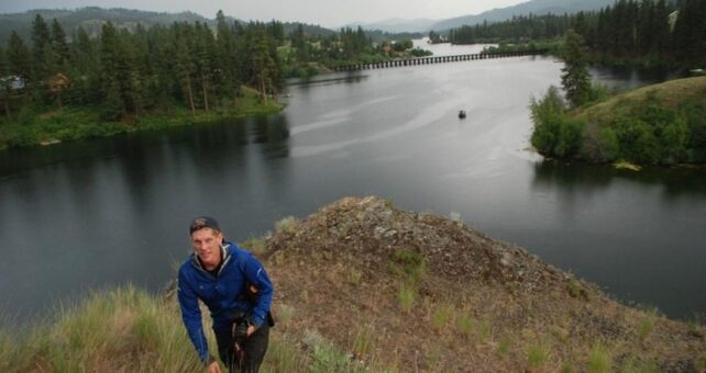 Bobby Whittaker, president of Ferry County Rail Trail Partners, with 770-foot trestle over Curlew Lake in background | Photo by Rich Landers