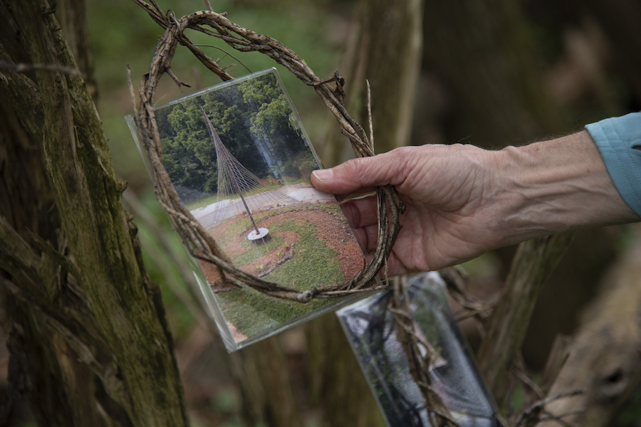 Bridget McCusker holds a photo of art in the park on the Gwynns Falls Trail | Photo by Arielle Bader