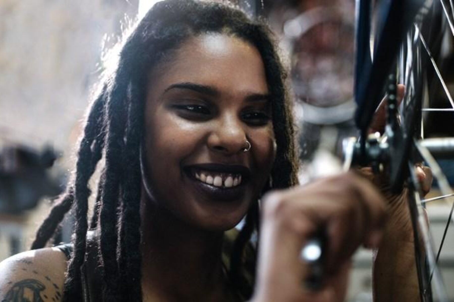 Female young technician looking at the camera in her bicycle repair shop | Photo courtesy RTC