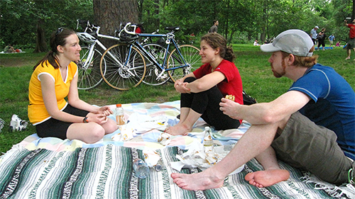 Friends having picnic in park with bikes