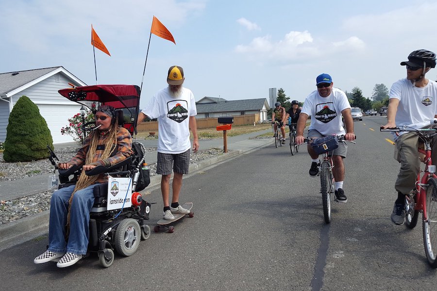 Ian Mackay's father, Scott, hitches a lift from his son in the town of Sequim during the homestretch of Mackay's ride across Washington in 2018. | Photo by Josh Sutcliffe