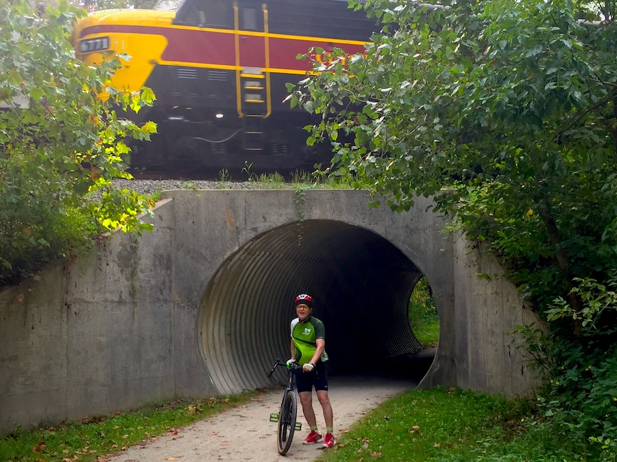 Jeff on the 2019 Trailblazer Tour on the Ohio & Erie Canal Towpath Trail with the Cuyahoga Valley Scenic Railroad passing overhead | Photo courtesy Rails-to-Trails Conservancy