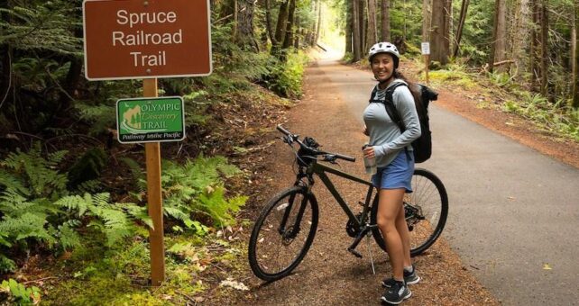 Kara Patajo @YourNorthWestieBestie on the Spruce Railraod Trail, part of the Olympic Discovery Trail | Photo courtesy Kara Patajo