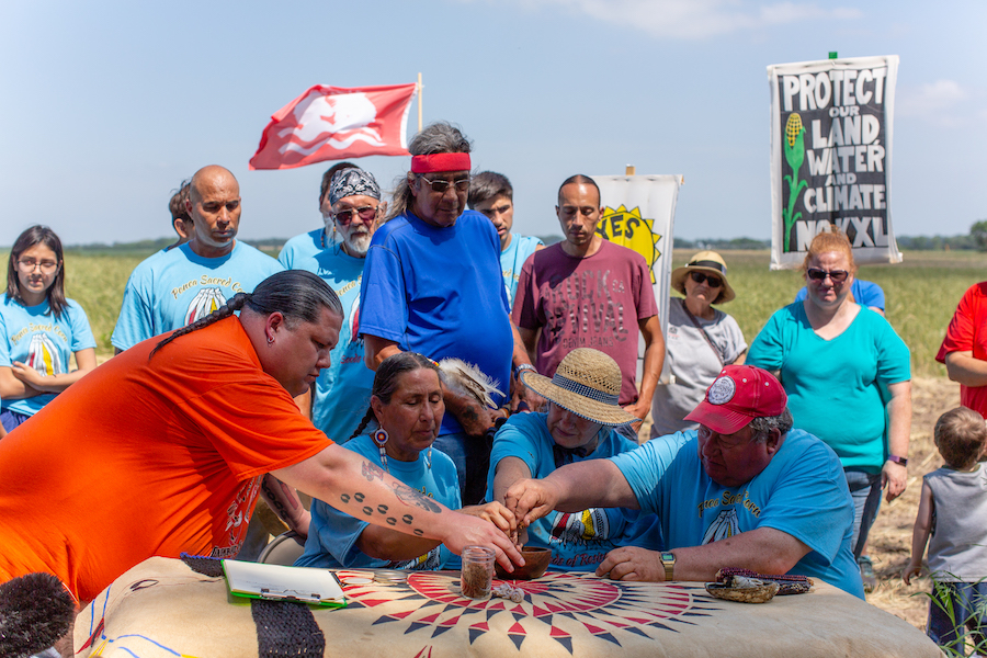 On June 10, 2018, Art and Helen Tanderup deeded a portion of their farm to the Ponca Nation in a public ceremony. Front, left to right are: Ponca Tribe of Nebraska Chairman Larry Wright, Jr., Ponca Nation of Oklahoma Councilwoman Casey Camp-Horinek, Helen and Art Tanderup. | Photo by Alex Matzke, courtesy Bold Nebraska