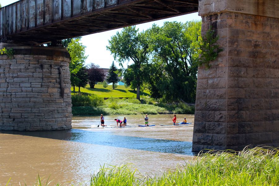 Paddleboarders on the Red River along the Greenway of Greater Grand Forks | Photo courtesy Visit Grand Forks