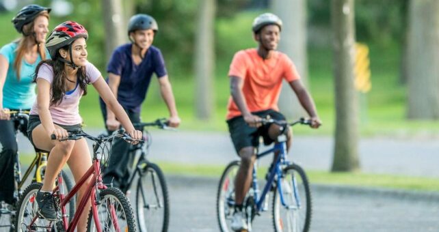 Young adults out riding bikes - Photo courtesy Getty Images