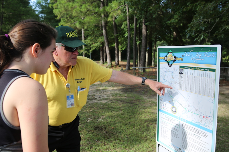 Tammany Trace Ranger Al Kurtz helps a patron on the trail | Photo courtesy St. Tammany Parish