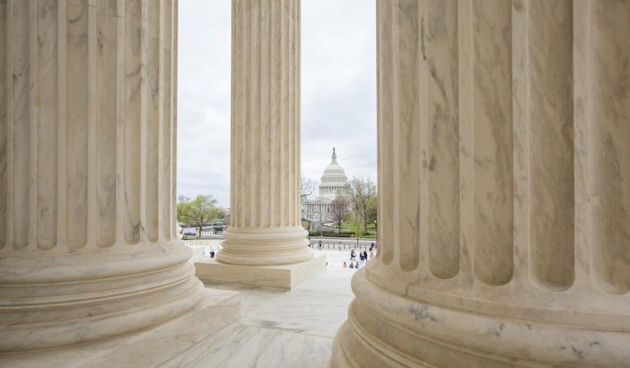 Columns of the United States Supreme Court with View of the Capitol in Washington DC