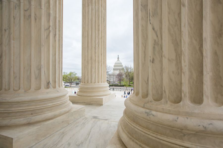 Columns of the United States Supreme Court with View of the Capitol in Washington DC