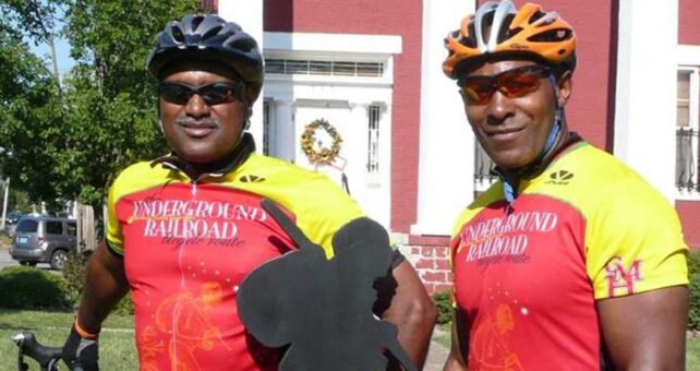 Mario Brown from the Center for Health Equity at the University of Pittsburgh and Adventure Cycling member George Thomas in front of Bertie Hall, along the Niagara River Recreation Trail in Ontario, Canada, during the 2007 inaugural tour of the Underground Railroad Bicycling Route | Photo by C. Spratling, courtesy Adventure Cycling Association