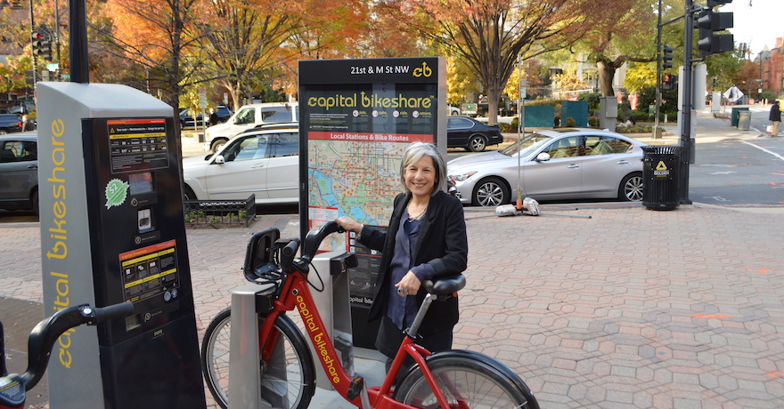 Andrea Ferster next to Capital Bikeshare bike | Photo by Eli Griffen