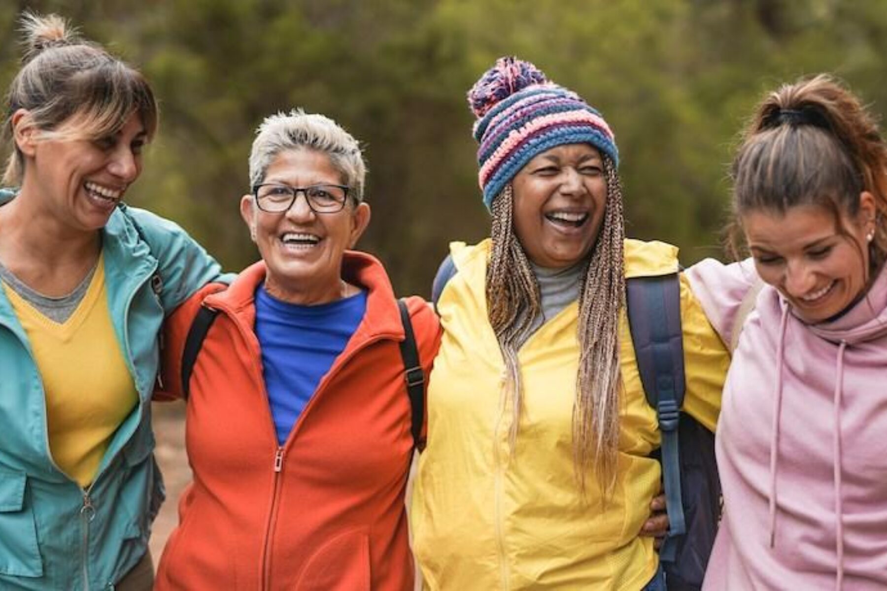 Happy multiracial women having fun embracing each outside - Photo courtesy Getty Images