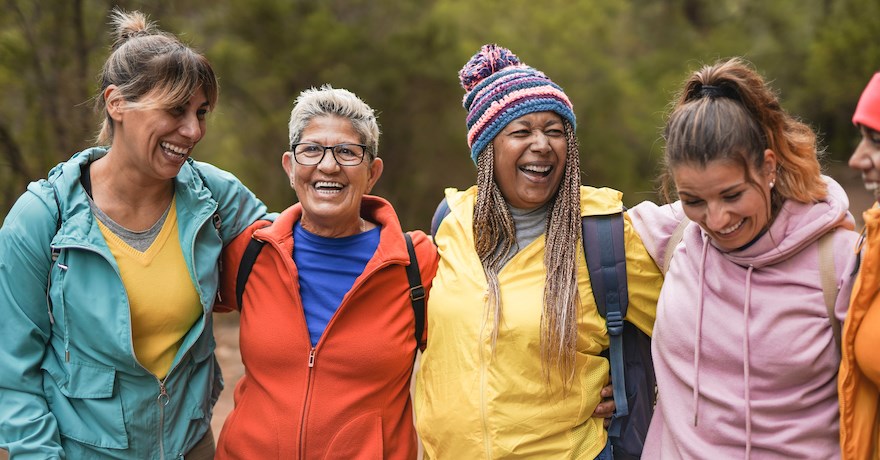 Happy multiracial women having fun embracing each outside - Photo courtesy Getty Images