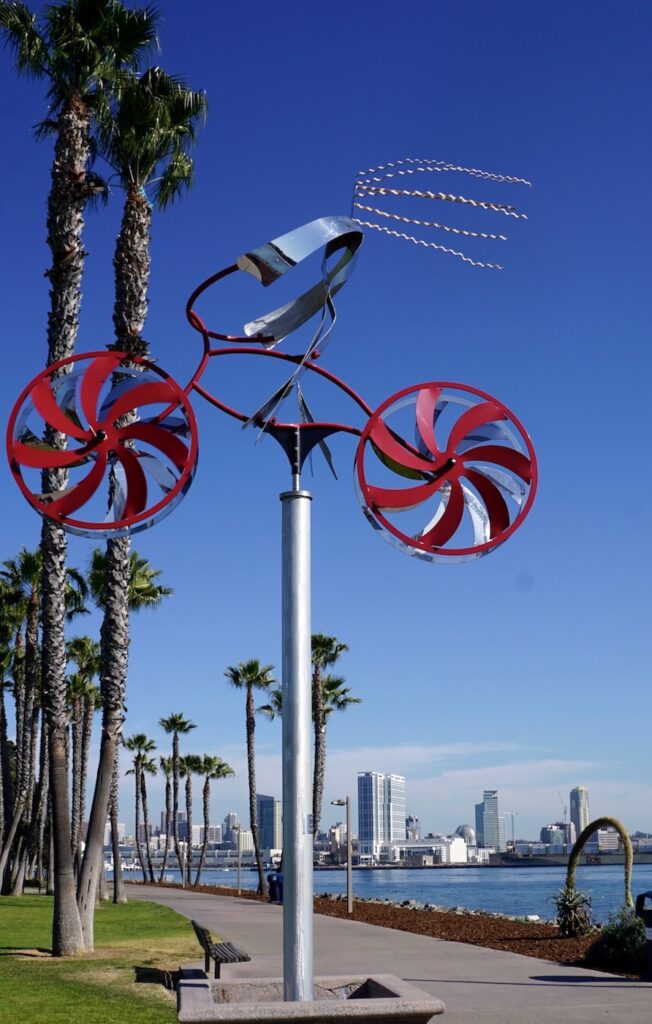 The “My Bike” sculpture, a work by artist Amos Robinson, soars above Coronado’s Tidelands Park. Across the Bay, the San Diego skyline provides a backdrop. | Photo by Cindy Barks