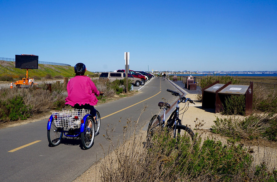 The flat, paved surface of the Bayshore Bikeway attracts a variety of wheeled transports, including bicycles, three-wheelers and rollerblades. Runners and walkers also frequent the separated section of trail that fronts the San Diego Bay. | Photo by Cindy Barks