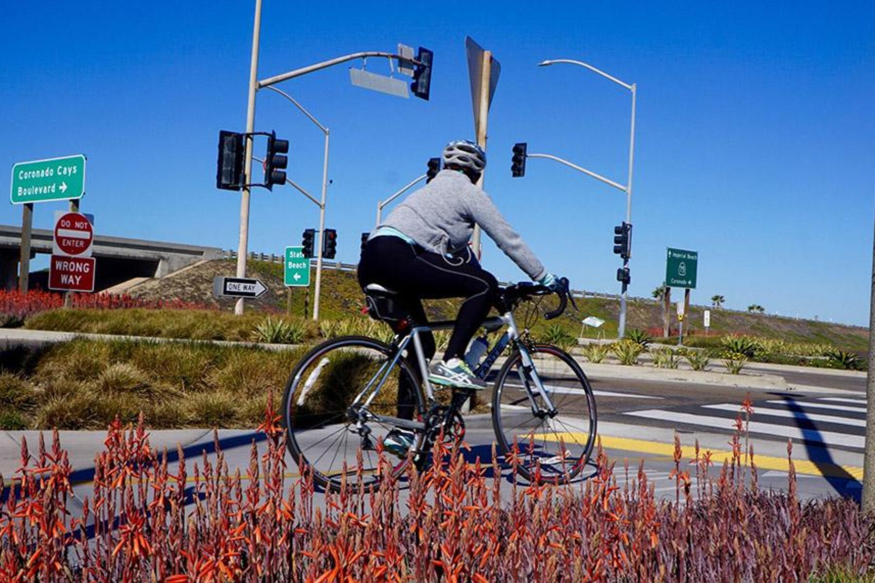 A Bayshore Bikeway cyclist navigates an intersection about 4.5 miles south of the City of Coronado, near the Silver Strand State Beach. The park features a long stretch of sandy beach along the Pacific coastline. | Photo by Cindy Barks