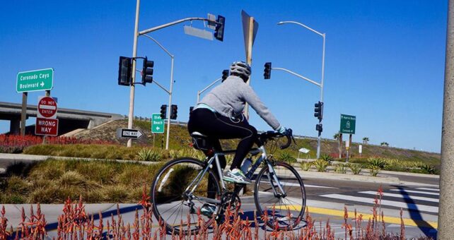 A Bayshore Bikeway cyclist navigates an intersection about 4.5 miles south of the City of Coronado, near the Silver Strand State Beach. The park features a long stretch of sandy beach along the Pacific coastline. | Photo by Cindy Barks